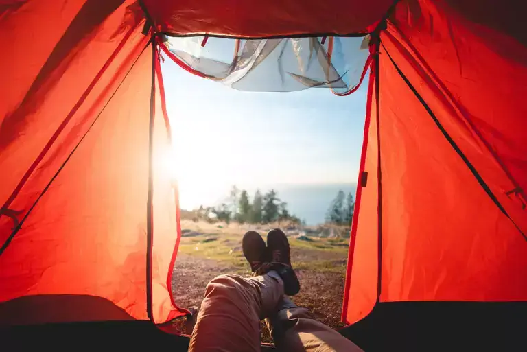 A man lying in a tent