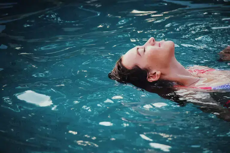 Woman lying in a swimming pool