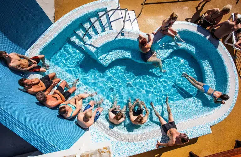 People sitting in a hot tub at Laugardalslaug