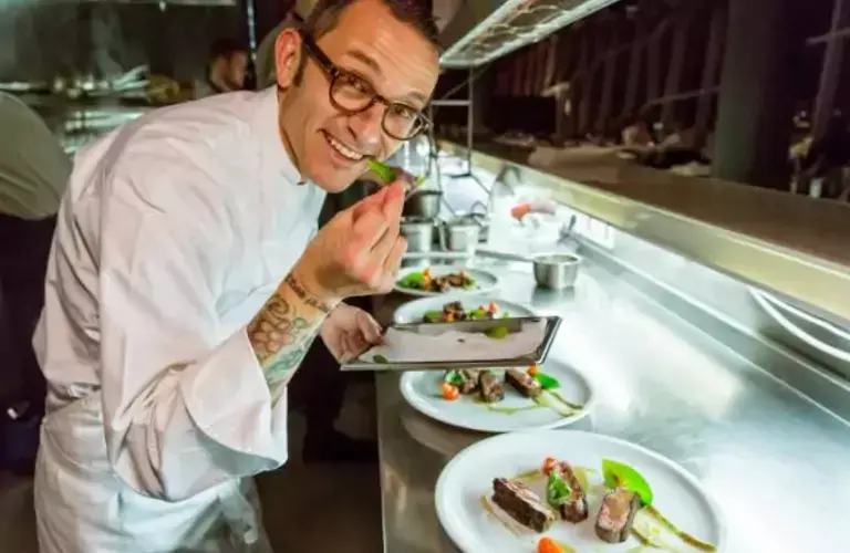 Chef with several food plates
