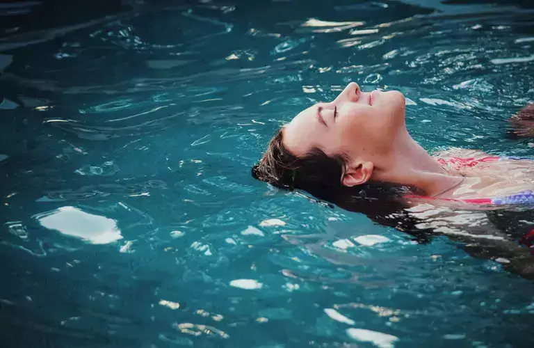 Woman lying in a swimming pool